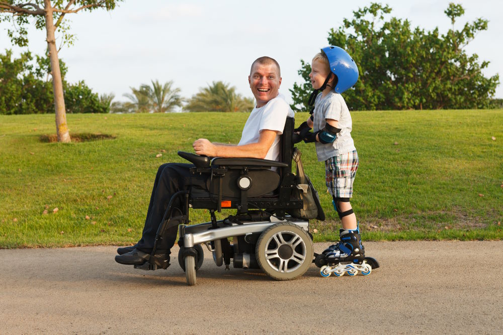 The photo above shows a dad in a wheelchair with his son rollerblading.